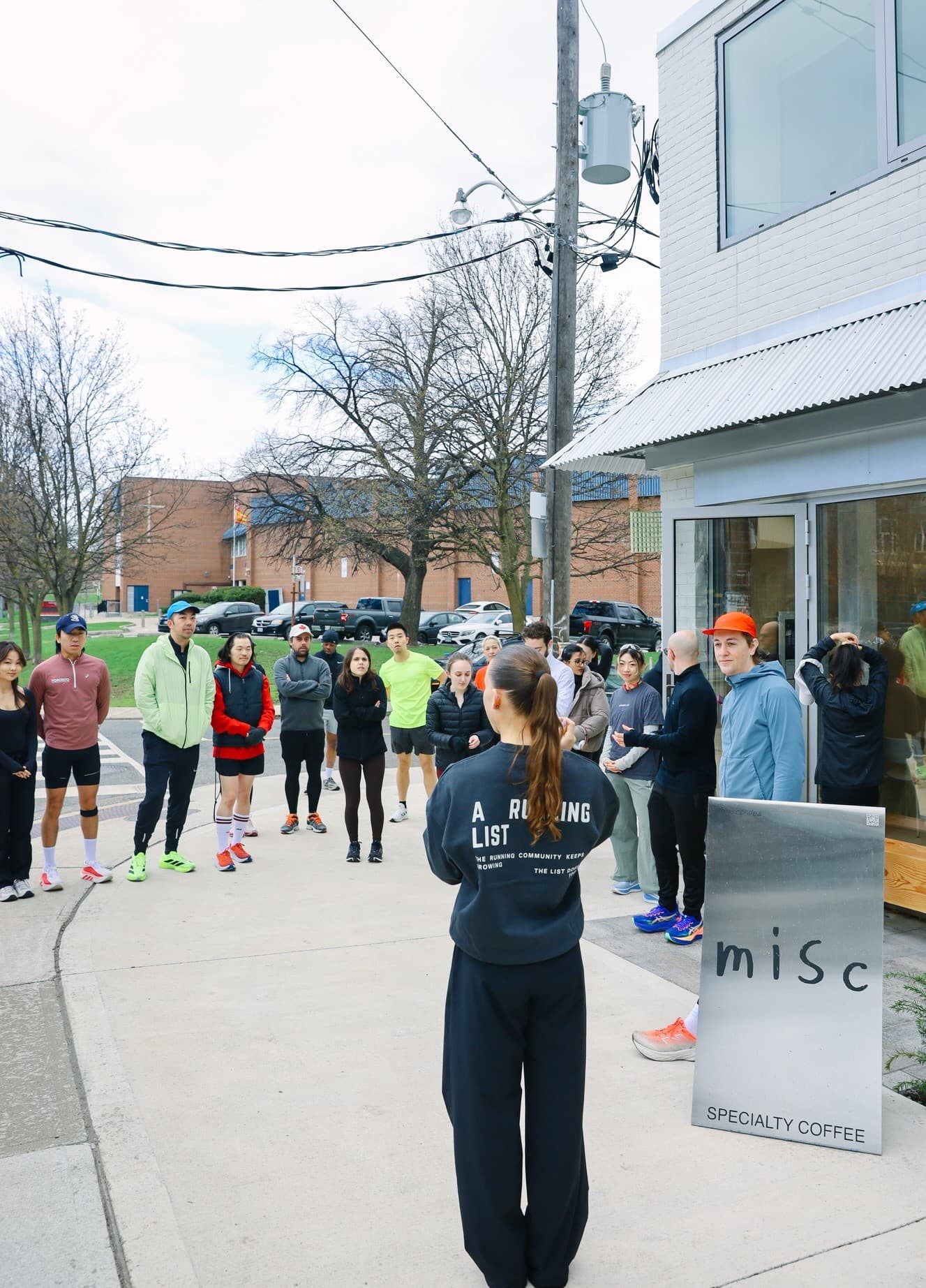 A Running List community run gathering outside the pop-up